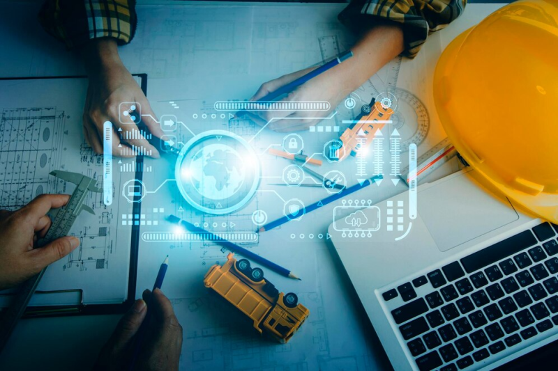 two colleagues discussing data working tablet laptop with architectural project construction site desk office_265022 7314